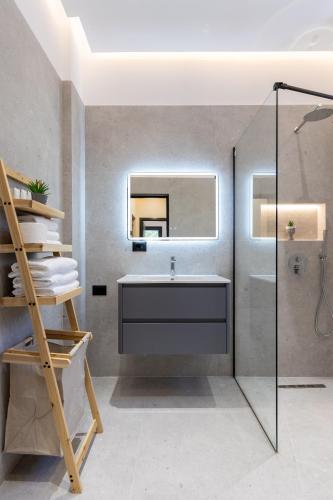a bathroom with a sink and a mirror at Olivium Rooms in Vlorë