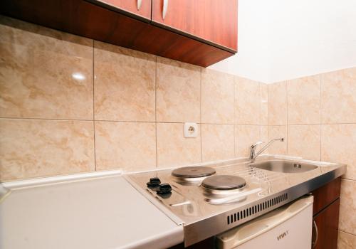 a kitchen with a stove and a sink at Villa Antonio in Ulcinj