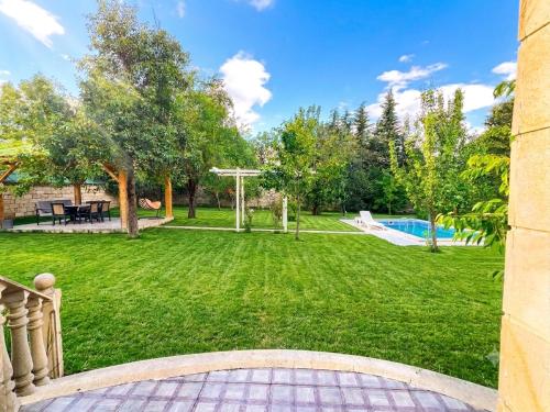 a view of a yard with a pool at Mountain View Deluxe Villa & pool in Gabala