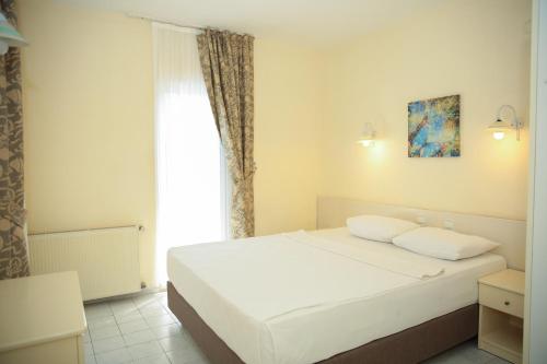 a bedroom with a white bed and a window at Life Apart in Marmaris