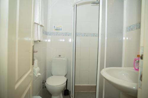 a white bathroom with a toilet and a sink at Life Apart in Marmaris