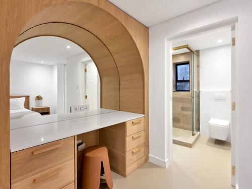 an archway in a bathroom with a sink and a toilet at Lily of the Valley - Higgovale in Cape Town