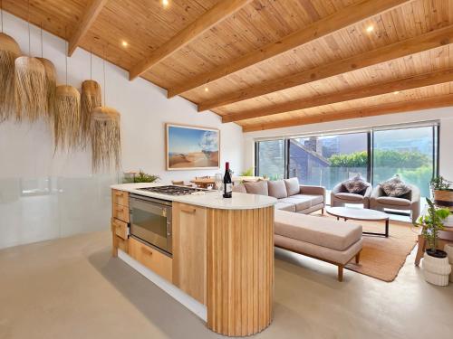 a kitchen and living room with a couch and a table at Lily of the Valley - Higgovale in Cape Town