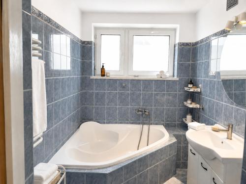 a bathroom with a tub and a sink at Nine to Trail Apartment in Wielka Wieś