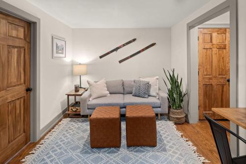 a living room with a couch and a table at Luxe Vermont Duplex in Stowe