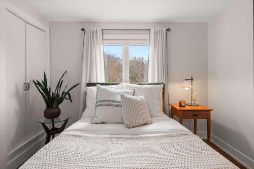 a bedroom with a large bed with a window at Luxe Vermont Duplex in Stowe