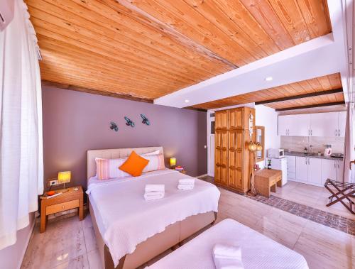 a bedroom with a bed and a wooden ceiling at DuruPduru Kaş in Kaş
