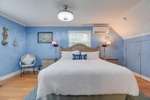 a bedroom with a large bed with blue walls at Andros Suite in Key West