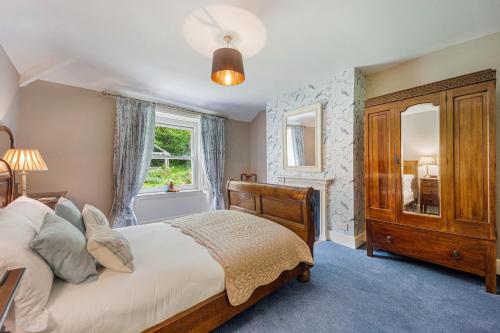 a bedroom with a large bed and a window at The West Wing in Whitford