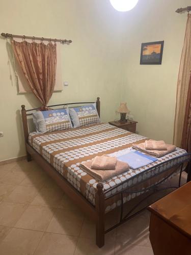 a bedroom with a bed with towels on it at Argoliki Thalassa in Myloi