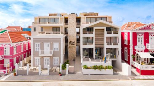 a rendering of a building with colorful houses at Art Hotel Curacao - Luxury Adults Only in Willemstad