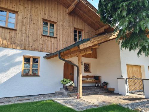 a house with a wooden roof at CHIEMSEE MOUNTAIN LODGE - adults only - Eleganz auf 95qm - Traumblick - XL-Balkon - Privatsphäre in Bernau am Chiemsee