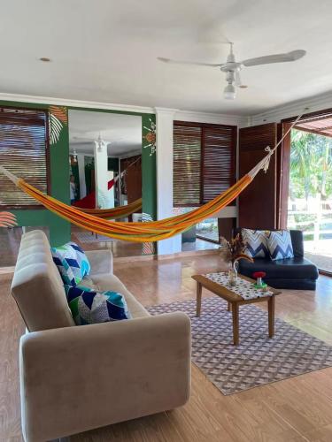 a living room with a couch and a hammock at Coccoloba Beach Hotel in Dibulla