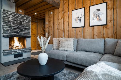 a living room with a couch and a fireplace at Chalet Ruka Aurelius in Ruka