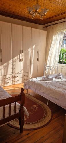 a bedroom with two beds and a window at Shkodra Green Heart in Shkodër