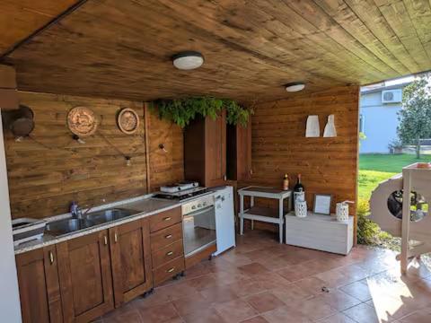 a kitchen with a sink and a stove at Casale del Miglio in Casorzo