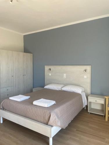 a bedroom with a bed with two towels on it at Paraschos Studios Kos in Kardamaina