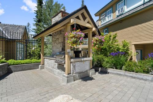 a patio with a barbecue grill in a house at The Snowbird by Whiski Jack in Whistler