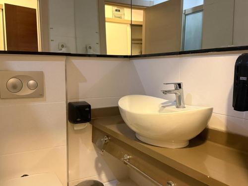 a bathroom with a sink and a mirror at Ayseli Hotel in Mersin