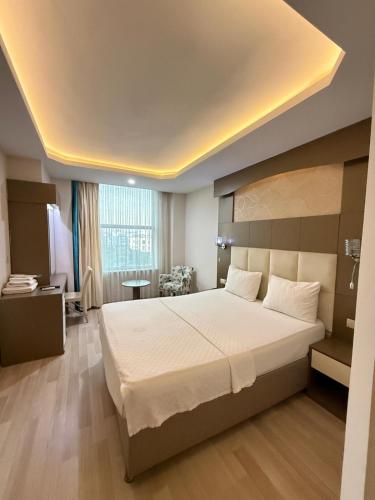 a bedroom with a large bed in a room at Ayseli Hotel in Mersin