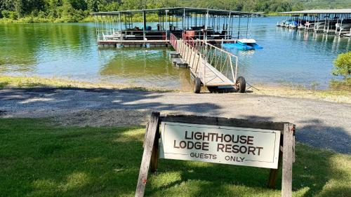a light house lodge resort sign in front of a lake at Lighthouse Lodge 4 in Kimberling City