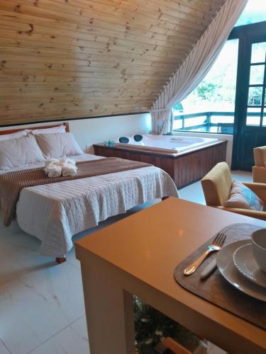 a bedroom with a bed and a bath tub at Sombra do baú - Aurora in Timbe do Sul