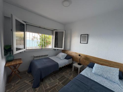 a bedroom with two beds and a window at Villa Blue Paradise in Vinarós
