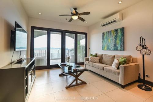 a living room with a couch and a flat screen tv at 360 Splendor 306-Ocean View Condo-Breakfast in Playa Flamingo