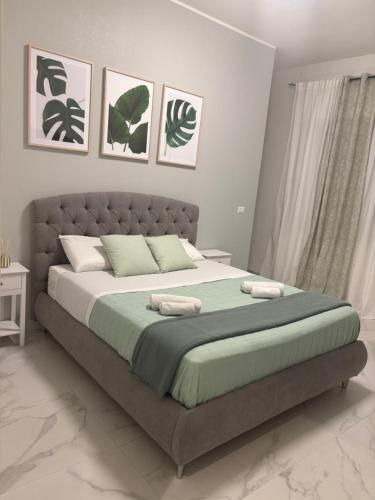 a bedroom with a large bed with two pillows at Karma apartment in Catania