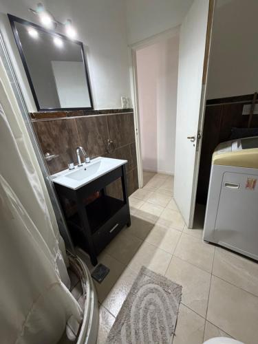 a bathroom with a sink and a mirror at San Francisco in Comodoro Rivadavia