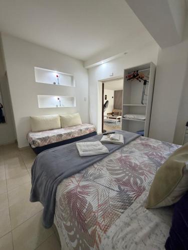 a bedroom with two beds and a mirror at San Francisco in Comodoro Rivadavia