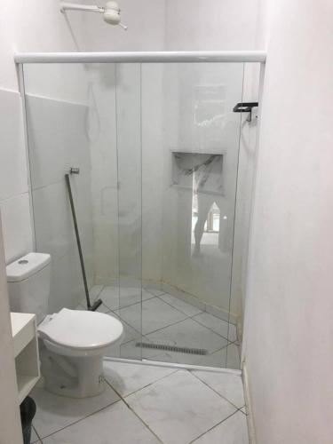 a glass shower in a bathroom with a toilet at Hospedaria Rancho Pérola in Guanambi