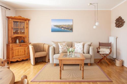 a living room with a couch and a table at Ferienwohnung Sonnenfreuden direkt am See, ideal für Paare in Überlingen