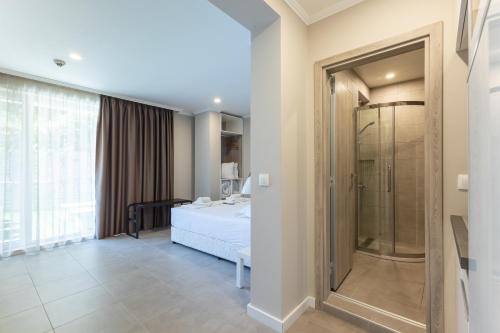 a bedroom with a bed and a glass shower at Sea lounge in Varna City