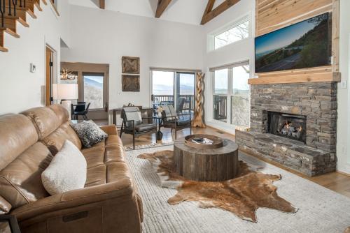 a living room with a couch and a fireplace at Misty Ridge Retreat in Blowing Rock