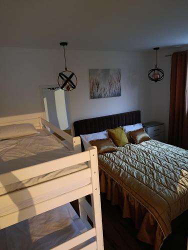 a bedroom with two beds and two lights at A&H Pliva Retreat in Jajce