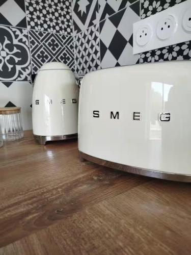 two toasters sitting on a wooden floor in a room at Le cocon de Jules et Chloé in Cléder