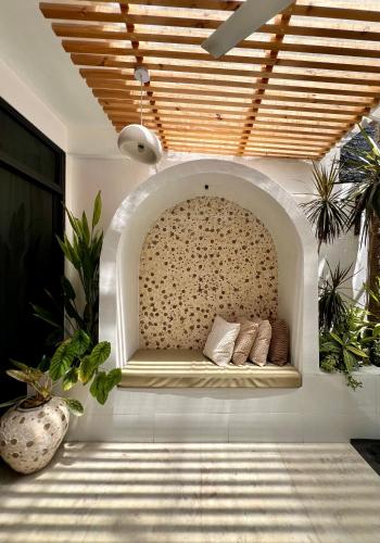 a bench in a wall in a room with plants at Sosun View Private Villa in Thoddoo