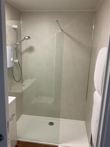 a shower with a glass door in a bathroom at Gara-Ni Bed & Breakfast in Fort William