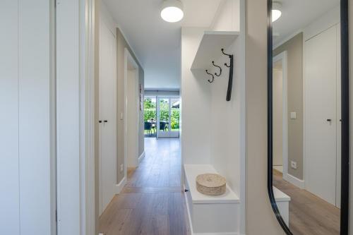 a hallway of a home with white walls and wood floors at Meersalz in Tinnum