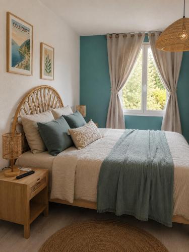 a bedroom with a large bed with a window at Résidence du Soleil & Spa - Collioure in Collioure