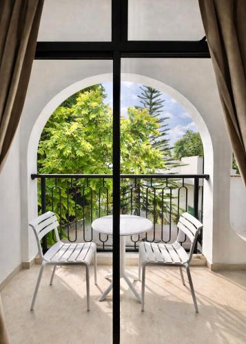 a table and chairs on a balcony with a view at Sosun View Private Villa in Thoddoo