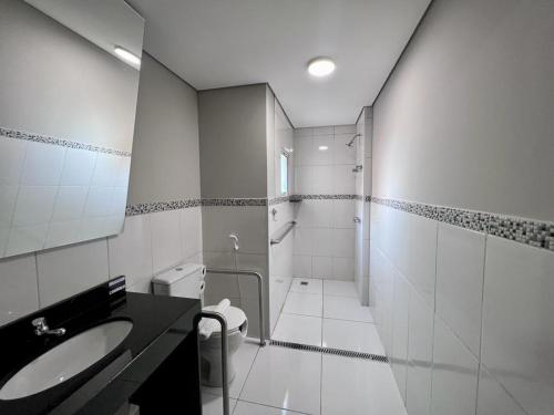 a bathroom with a sink and a toilet at Asa Hotel in Piracicaba
