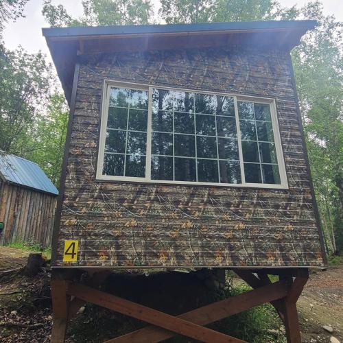 a house being constructed with windows on top at Camo Cabin #4 in Houston
