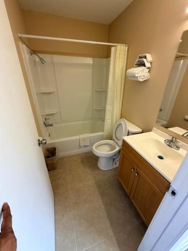 a bathroom with a toilet and a sink at Ranch House Motel in Marksville