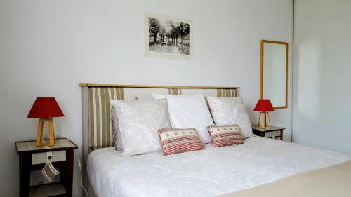 a bedroom with a white bed with two lamps at Provence Luberon Goult Gite Mafasuza in Goult