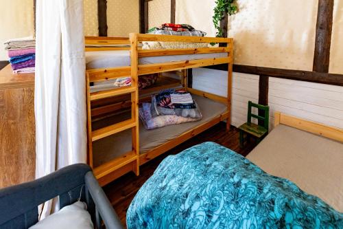 a room with two bunk beds and a bed at Pie lacuksa in Tīnūži