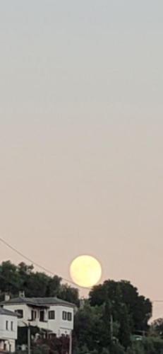 a yellow disk in the sky over a city at Iris Sea View Villa in Afissos