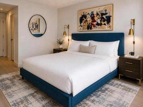 a bedroom with a blue and white bed and a mirror at Bluebird Suites at Georgetown in Washington, D.C.