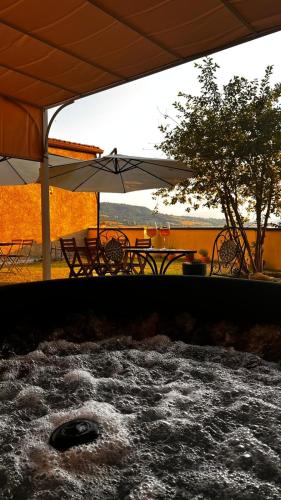 a patio with a table and chairs and an umbrella at San Leo Albergo Diffuso in San Leo